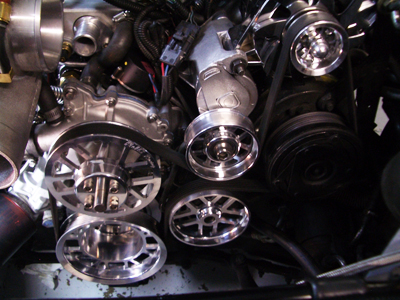 Close-up of car engine with chrome pulleys