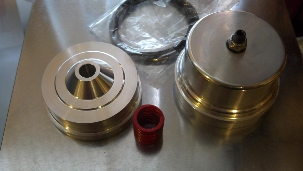Precision-machined parts with red spring
