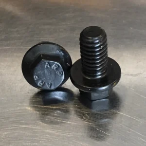 Black ARP bolts on metal surface