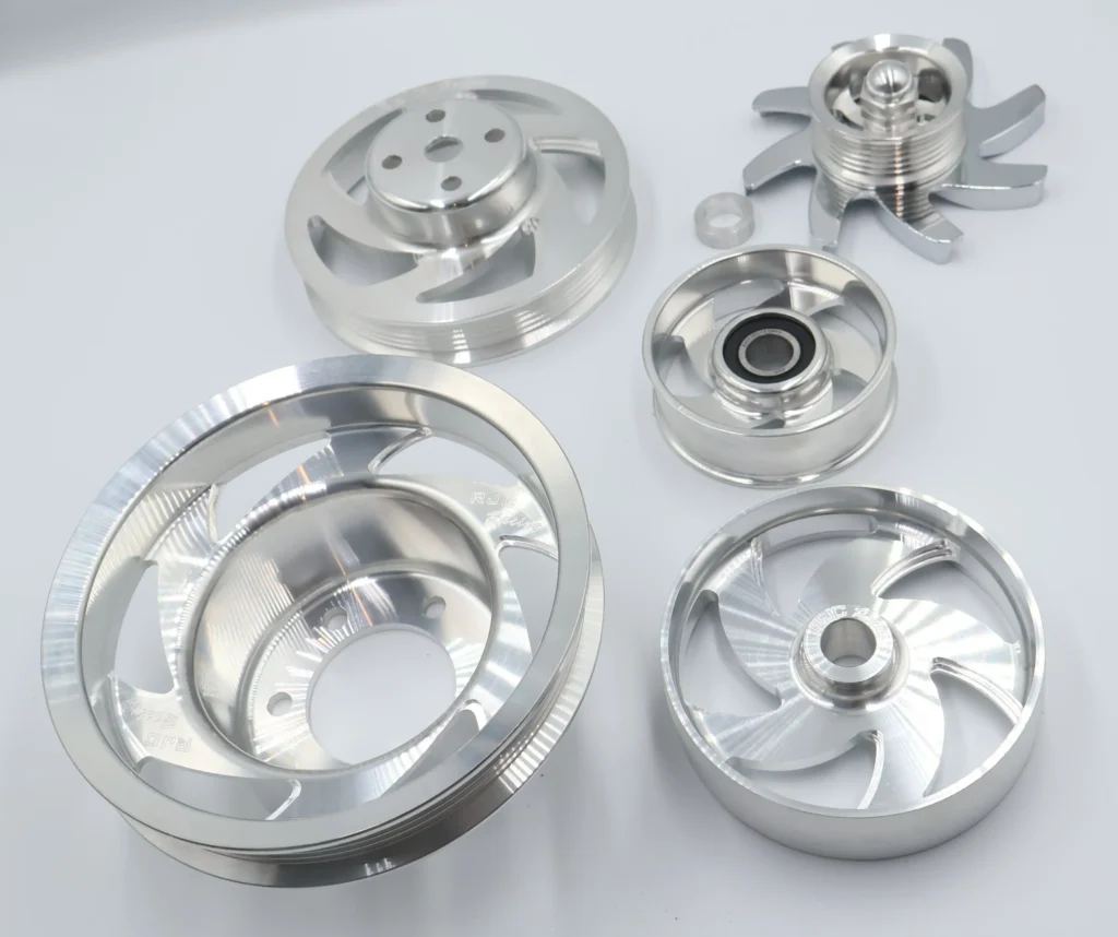 Silver auto parts, pulleys, and fans