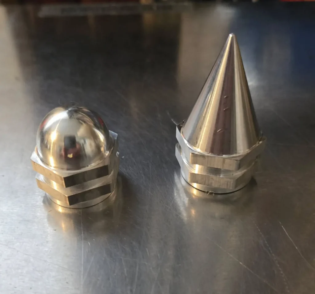 Two polished metal nuts, different shapes