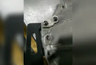 Engine part attached to a black bracket